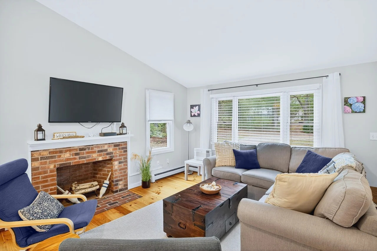 Living room with a sofa, chairs and natural light