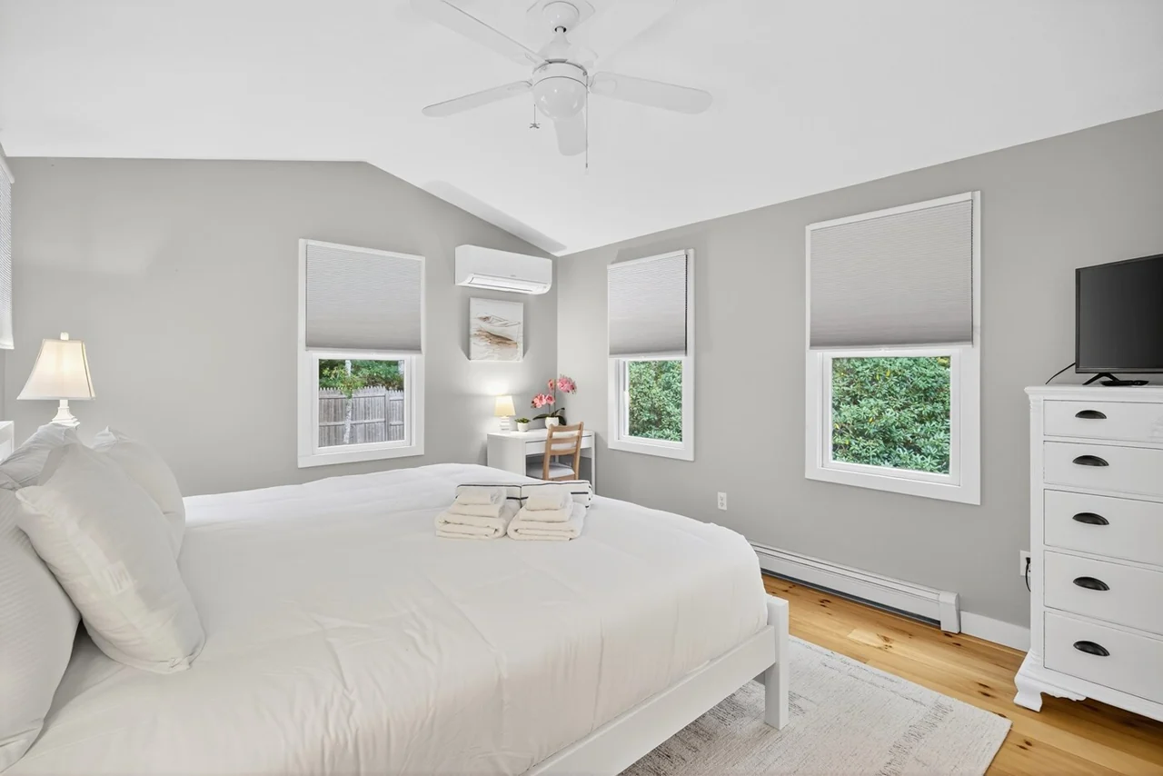 King bedroom with a desk and TV