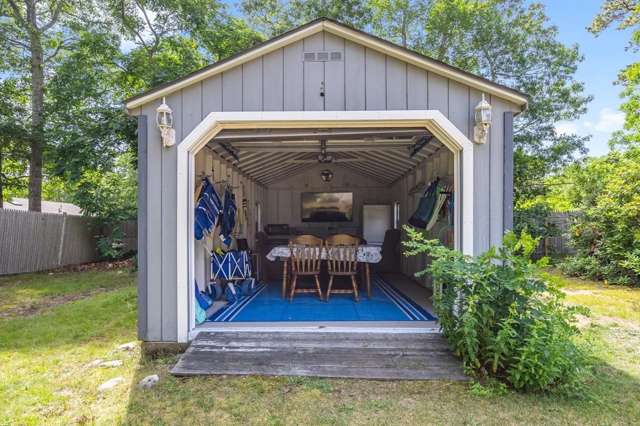 Separate backyard game shed with seating